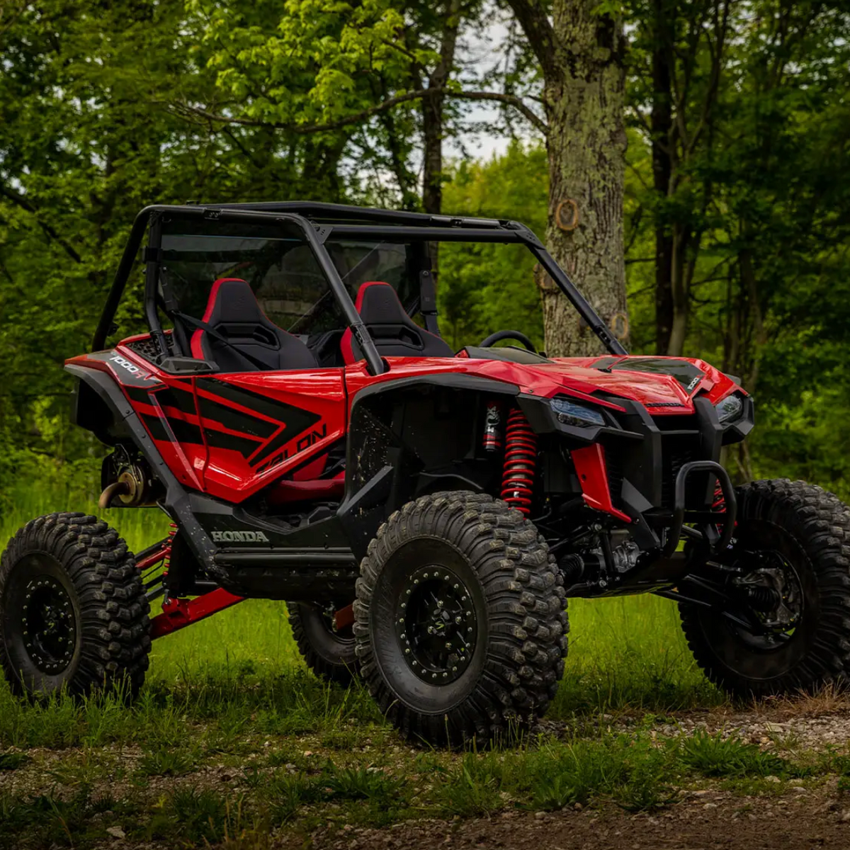 Honda Talon with accessories like aftermarket wheels, bigger tires, aftermarket a arms, and a back windshield 